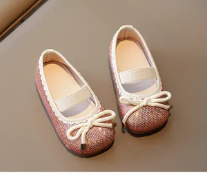 Detailed top view of sparkling pink gold sequined girls flat shoes with bow tie decor