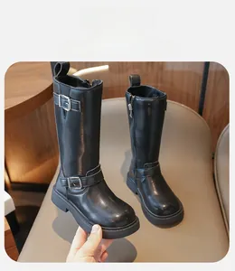 Detail of girls' black matte leather mid-calf boots with metal buckles and side zipper