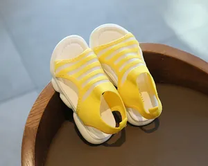 Detail of yellow knit toddler sandals with breathable mesh and thick white soft soles