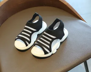Detail of girls striped knit sandals featuring breathable open toe and thick wavy soles