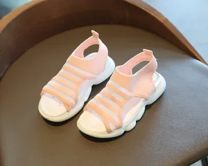 Detailed view of pink breathable mesh toddler sandals with thick white rubber soles