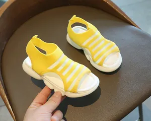 Close-up of girl's yellow mesh sandal featuring a soft white thick sole for summer comfort