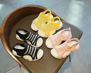 Detailed view of children's knit sandals in yellow, black, and pink colors