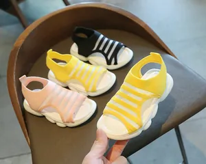 Detailed close-up of breathable knit girls' summer sandals in pink, yellow and black