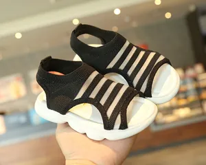 Close-up of girls striped knit sandals with thick cushioned soles for summer beach