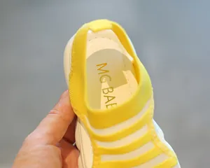 Detailed macro view of girls' yellow striped beach sandal showing the soft inner sole
