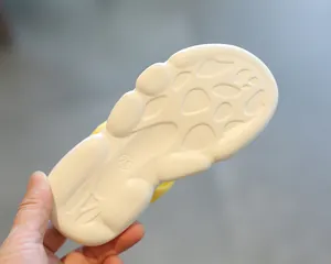 Close-up of white EVA thick sole with non-slip texture and size 26 marking on girls sandal