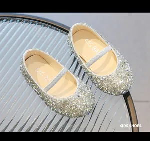 Close-up of sparkling silver sequin Mary Jane shoes for girls with elastic strap detail