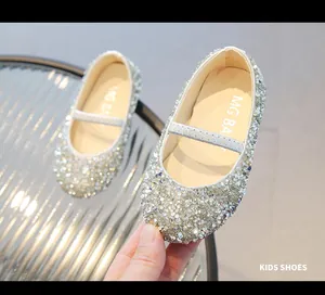 Close-up of sparkling silver sequins and elastic strap on girls glitter mary jane shoes