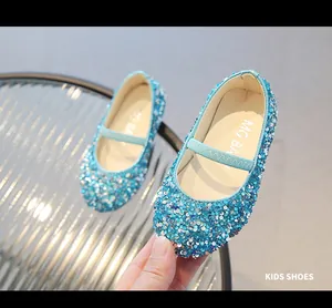 Macro shot of blue sequined Mary Jane princess shoes with elastic strap and MG BABY logo