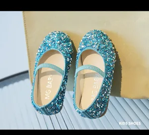 Close-up of sparkling blue and silver sequins and elastic strap on girls' flat princess shoes
