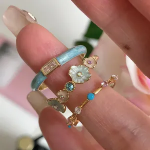 Three-piece stackable ring set with blue enamel flowers and sparkling zircon stones