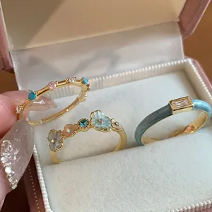 Three-piece ring set with blue enamel, flower designs and colorful cubic zirconia in velvet box