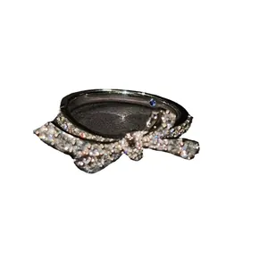 Sparkling bow-shaped silver ring with micro-paved zircons and hidden blue inner stone