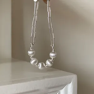 Detail of s925 silver beaded bracelet showing brushed matte texture and liquid silver tubes