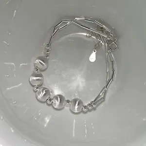 Macro view of 925 sterling silver beaded bracelet with frosted beads and S925 hallmark