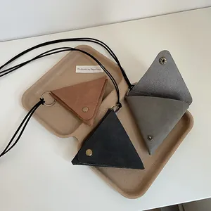 Three triangular leather neck pouches in brown, gray, and black with retro metal snaps