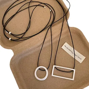 Minimalist geometric brushed metal pendant necklace set with adjustable black cord strap