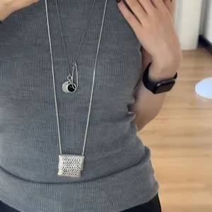 Détail du pendentif carré tissé sur chaîne serpent longue avec collier pièce superposé