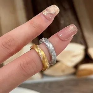 Brushed metal twisted rings with zircons in gold and silver finish for women