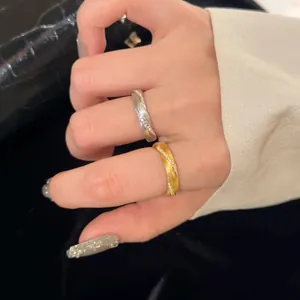 Textured twist zircon rings set in gold and silver finish worn by a model