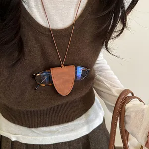 Close-up of caramel brown faux leather neck-hanging magnetic sunglasses holder on a model