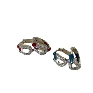 U-shaped horseshoe hoop earrings with red and blue enamel and sparkling cubic zirconia