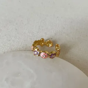 Detailed view of floral enamel pattern on golden adjustable open ring for women
