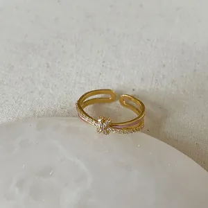 Detailed view of adjustable golden butterfly ring with sparkling zircon stones