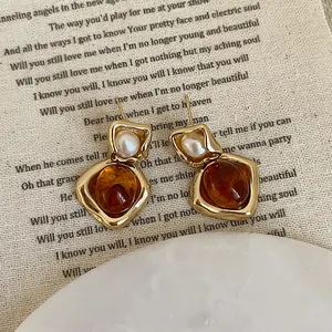Irregular amber resin and pearl earrings in retro gold frame for elegant women