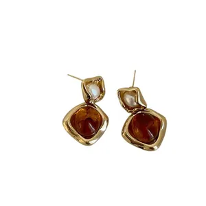 Irregular amber resin earrings with white pearls and vintage gold metal frames