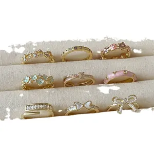 Set of 9 gold flower and butterfly open rings with pearls and enamel for women