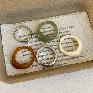 5-piece geometric resin and silver metal ring set in green, amber, and milk white