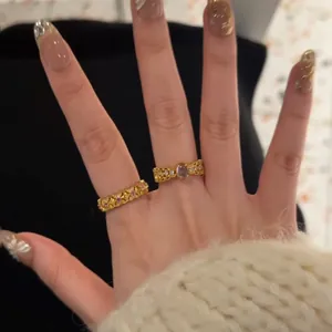 Vintage gold ring set with oval purple gemstone and pink crystals on hand display