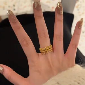 Detail of vintage gold layered bell rings with amethyst accent and shiny rhinestones