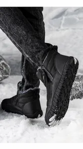 Detail of waterproof snow boot with anti-slip rubber sole on outdoor snow background