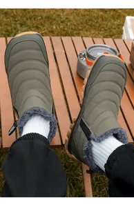 Detail view of men's olive green outdoor snow boots with thick fleece lining