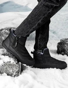Detailed close-up of side zipper and thick gray plush lining on black winter snow boots