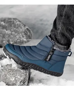 Detail of blue men's winter snow boot with side zipper and thick fleece lining on snow