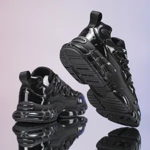 Detailed view of chunky black platform sneakers with glossy patent leather and mesh texture