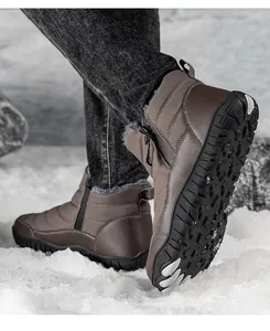 Detailed view of the anti-slip rubber sole and warm faux fur lining of brown snow boots