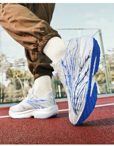Detail of white mesh running shoes featuring blue graphic print and rotating buckle