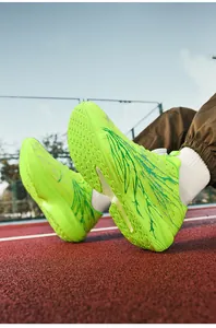 Detail of neon green running shoes featuring a swivel lacing system on a track