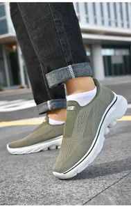 Detail of army green breathable knit mesh slip-on shoe with white cushioned sole