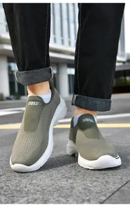 Close-up of olive green breathable knitted upper and slip-on design on men's walking shoes