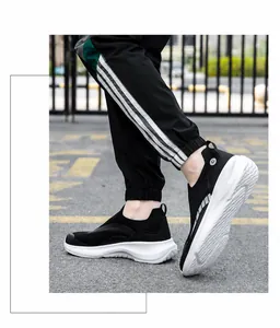 Close-up van zwarte ademende mesh slip-on sneakers met dikke witte gedempte zolen