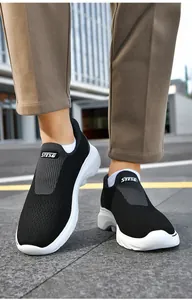 Detail of breathable fly-knit mesh upper and elastic strap on slip-on walking shoes