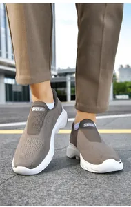 Close-up of breathable knit slip-on walking shoes on feet for senior men's comfort