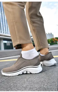 Macro detail of breathable khaki mesh fabric and thick anti-slip sole on men's slip-on sneaker