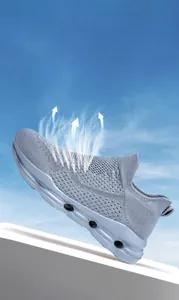Detail of breathable knit upper and hollowed-out sole on light blue outdoor sneakers